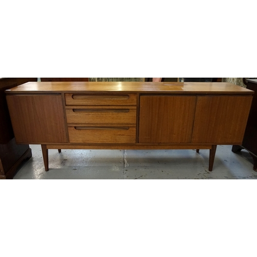 467 - ALFRED COX TEAK SIDEBOARD
with three long drawers with lip handles, a single cupboard door and a pai... 