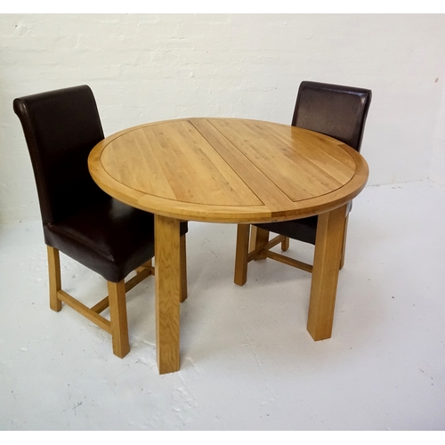 423 - CIRCULAR LIGHT OAK EXTENDING DINING TABLE
with a pull apart top revealing a fold out leaf, standing ... 