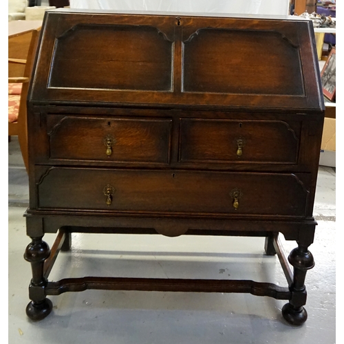 436 - 18th CENTURY STYLE OAK BUREAU
with a panelled fall flap opening to reveal an inset tooled leather to... 