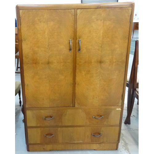 381 - WALNUT DRESSING CHEST
the raised back above a pair of cupboard doors with two drawers below, standin... 