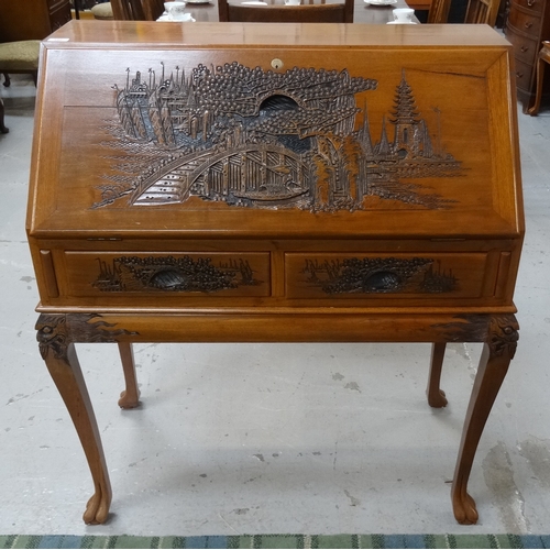 390 - MALAYSIAN TEAK BUREAU
on a stand, with a carved fall flap and sides above two carved frieze drawers ... 