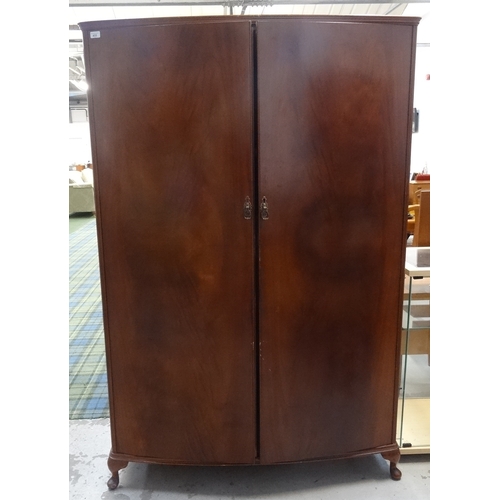 433 - BEITHCRAFT MAHOGANY BOW FRONT WARDROBE
with a moulded top above above two doors opening to reveal a ... 