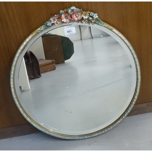 461 - CIRCULAR WALL MIRROR
with a bevelled plate contained in a floral decorated frame, 48cm wide, togethe... 