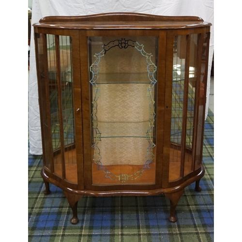 91 - 1950'S WALNUT BOW FRONT DISPLAY CABINET
with a raised back above a glazed central door flanked by a ... 