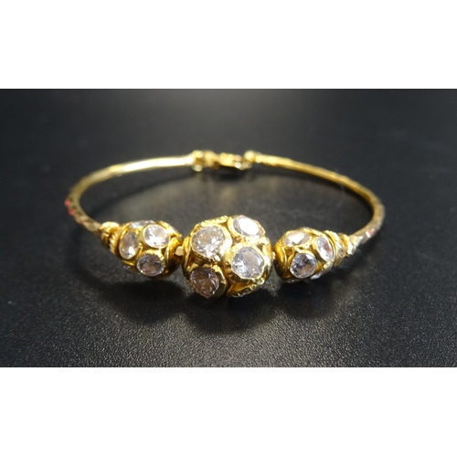 59 - TWENTY-TWO CARAT GOLD CHILD'S BRACELET
with crystal decoration, 4.4cm diameter, total weight approxi... 
