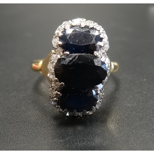 60 - SAPPHIRE AND DIAMOND CLUSTER DRESS RING
the central three oval cut sapphires in unusual vertical set... 