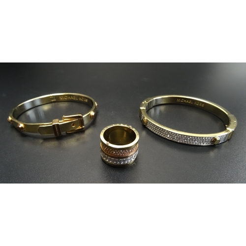 69 - SELECTION OF MICHAEL KORS JEWELLERY
comprising two bangles, one pave set and another of buckle desig... 