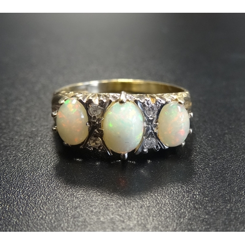 71 - OPAL AND DIAMOND RING
the three oval cabochon opals separated by small diamonds, on nine carat gold ... 