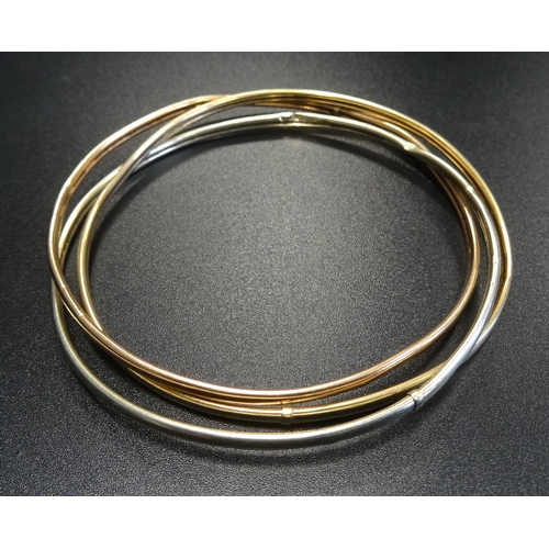 78 - NINE CARAT GOLD RUSSIAN WEDDING RING STYLE TRIPLE BANGLE
comprising white, yellow and rose gold entw... 