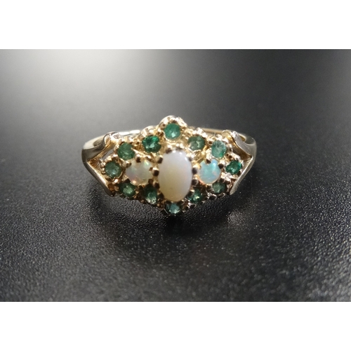 96 - OPAL AND EMERALD CLUSTER RING
the three central opals in emerald surround, on nine carat gold shank,... 