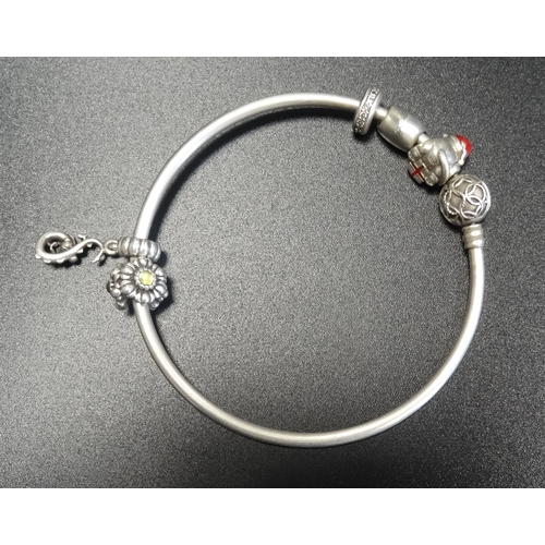 119 - PANDORA MOMENTS SILVER CHARM BANGLE
the clasp with entwined decoration, with five Pandora charms inc... 