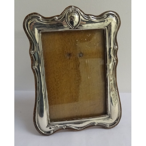 141 - GEORGE V SILVER PHOTOGRAPH FRAME
of shaped outline with easel support, Birmingham hallmarks for 1914... 