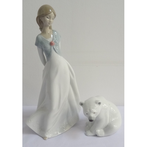 163 - LLADRO POLAR BEAR
sat on its haunches, 8.5cm high, together with a Nao figurine of a young girl, 25c... 