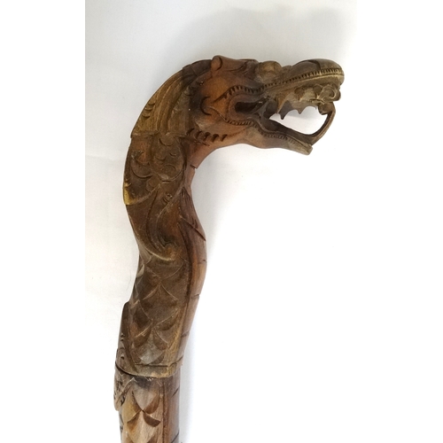 210 - EAST ASIAN TEAK WALKING STICK
carved as a decorative dragon with its open mouth forming the handle, ... 