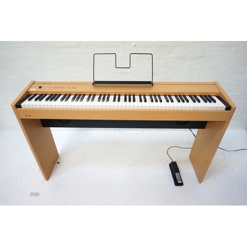 242 - ROLAND F-90 DIGITAL PIANO
in a maple style case with an eight eight note digital piano hammer action... 