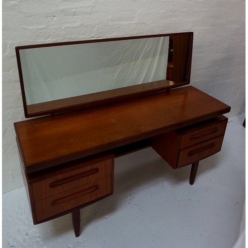 433 - G PLAN TEAK DRESSING TABLE
with an adjustable oblong mirror back above a moulded top with a conceale... 