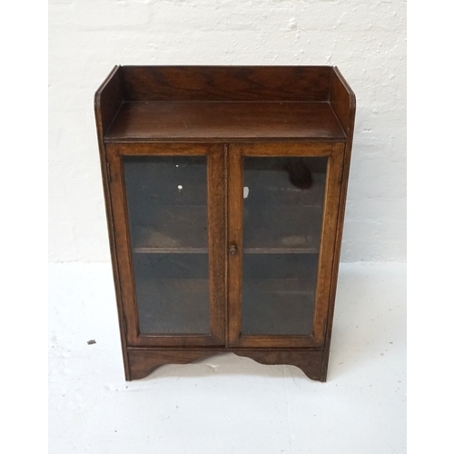 432 - OAK GLAZED BOOKCASE
early 20th century, with gallery top above two glazed doors with shelf interior,... 