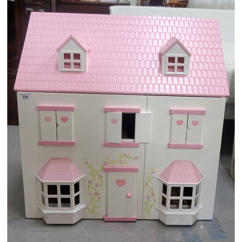 259 - CHILD'S DOLLS HOUSE
of wooden and plastic construction with an opening double front revealing two fl... 