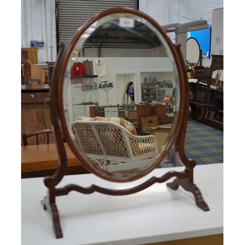 414 - GEORGIAN STYLE DRESSING TABLE MIRROR
with an oval bevelled plate in a mahogany frame, with splayed s... 