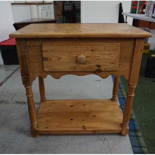 434 - WAXED PINE SIDE TABLE
with a moulded top above a single deep drawer with a shaped frieze below, stan... 