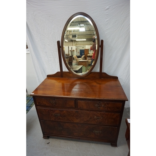 435 - EDWARDIAN WALNUT AND FIGURED WALNUT DRESSING CHEST
with a bevelled oval mirror back above two short ... 