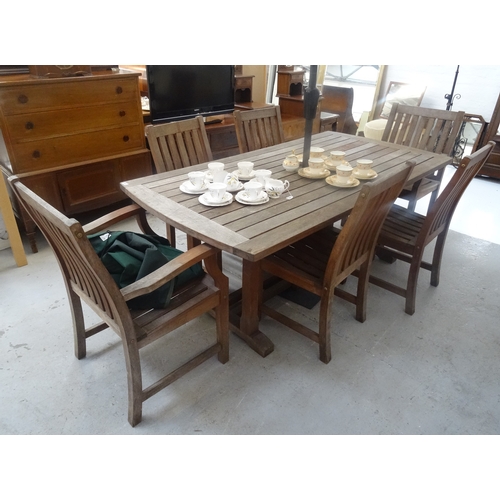 409 - LARGE TEAK GARDEN TABLE
with a slatted top and shaped ends, standing on shaped supports with splayed... 