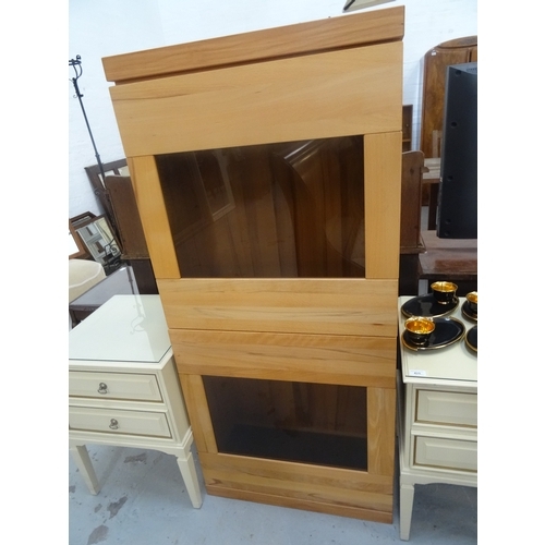 413 - BEECH SIDE CABINET
with a plain moulded top above two smoked glass panel doors with interior glass s... 