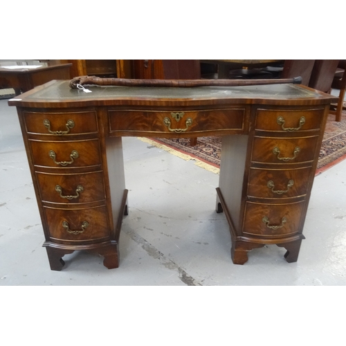 422 - MAHOGANY SERPENTINE FRONT KNEEHOLE DESK
with leather skiver, raised on graduated four drawer pedesta... 