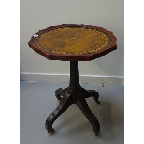 80 - WINE TABLE
with leather skiver top on the shaped top, raised on a tapering pedestal with quatrofoil ... 