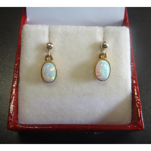 12 - PAIR OF OPAL DROP EARRINGS
the oval cabochon opals in nine carat gold
