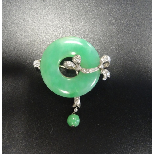 24 - ATTRACTIVE JADE AND DIAMOND BROOCH
the ring of green jade with diamond set ribbon detail and further... 