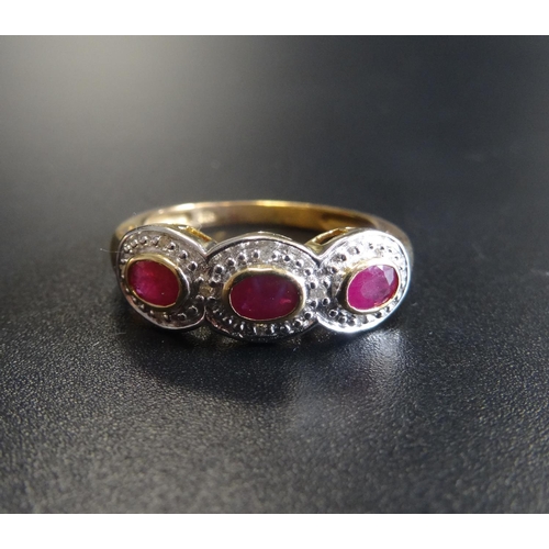 41 - RUBY AND DIAMOND DRESS RING
the three oval cut rubies in textured surround set with small diamonds, ... 