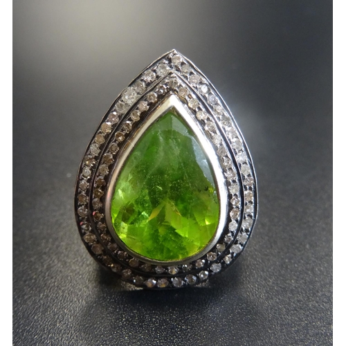 58 - UNUSUAL PERIDOT AND DIAMOND CLUSTER RING
the large central pear cut peridot approximately 7.5cts in ... 