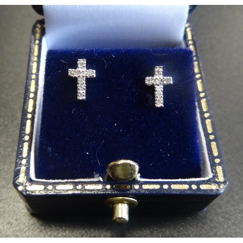 65 - PAIR OF DIAMOND CLUSTER STUD EARRINGS
in the form of crosses, in nine carat white gold  -  RE-OFFERE... 