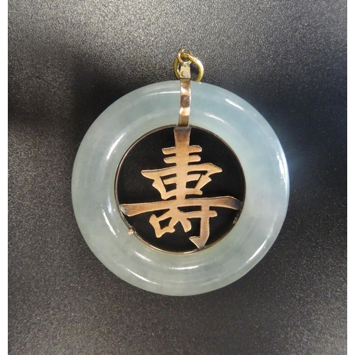 69 - JADE AND TEN CARAT GOLD PENDANT
the outer ring of jade with gold Chinese character to the centre, 4c... 