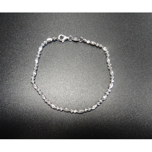 91 - NINE CARAT WHITE GOLD BRACELET
the beads with cut decoration, 16.7cm long and approximately 2.9 gram... 