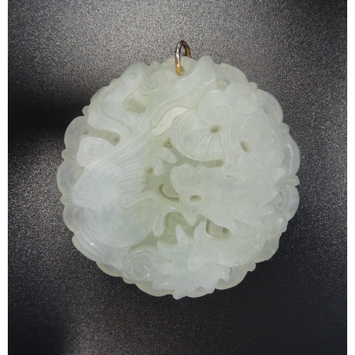 130 - CHINESE CARVED JADE COLOURED HARDSTONE PENDANT
depicting a dragon and an exotic bird, approximately ... 