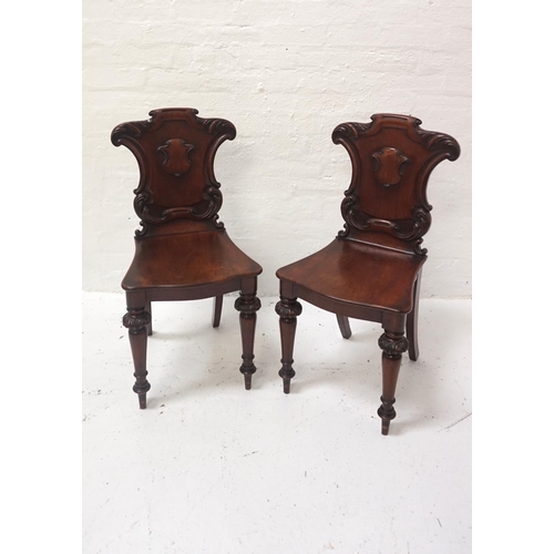 505 - PAIR OF VICTORIAN MAHOGANY HALL CHAIRS
with carved and shaped backrests, shaped seats, raised on car... 