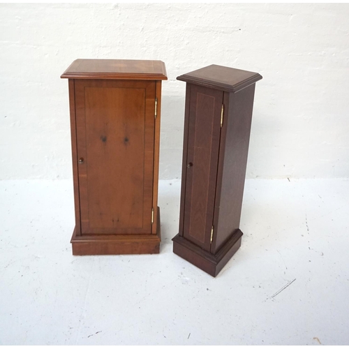 519 - YEW CD STORAGE TOWER
with moulded top and panel door, standing on a plinth base, 75cm high; along wi... 