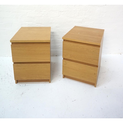 525 - PAIR OF LIGHT OAK BEDSIDE CABINETS
each with two drawers, standing on a plinth base, 55cm high  -  R... 