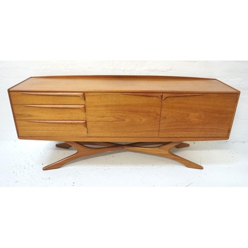 560 - BEITHCRAFT TEAK SIDEBOARD
the shaped raised back above an oblong top, with three drawers below and a...
