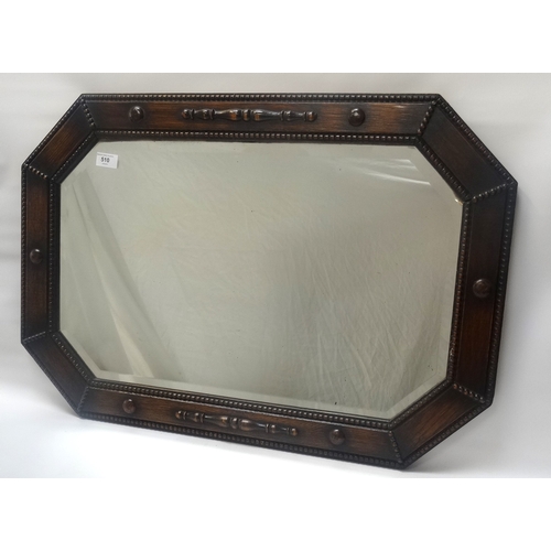 510 - 1920s OAK OCTAGONAL FRAME WALL MIRROR
with bevelled plate, the frame with raised detail, 54cm high x... 