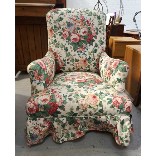 558 - MID VICTORIAN ARMCHAIR
with outswept arms and covered in a later floral fabric, standing on turned f... 