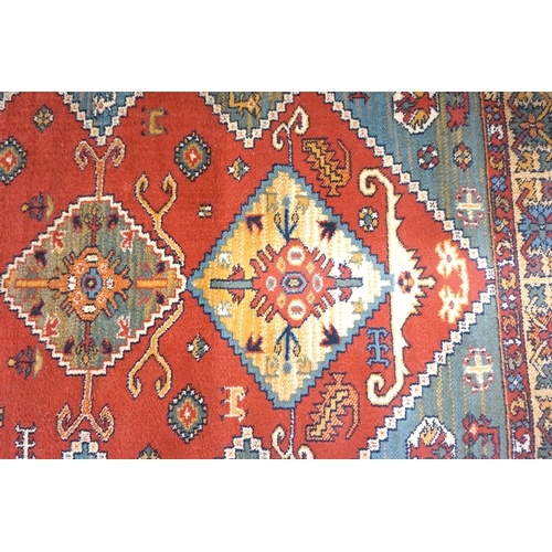 542 - KASHMIRI RUG
decorated with geometric motifs, encased in a blue and terracotta border, 170cm x 120cm