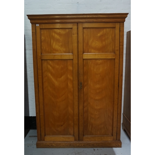 541 - VICTORIAN PINE WARDROBE
with a cavetto flat top above a pair of panelled doors opening to reveal han... 