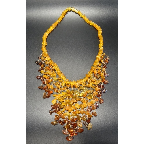 7 - MODERN AMBER BEAD NECKLACE
the varying shades of amber in graduated fringed front piece, approximate... 