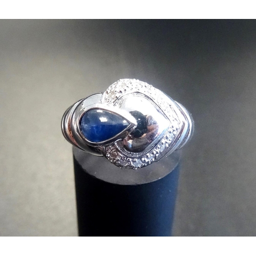 130 - UNUSUAL SAPPHIRE AND DIAMOND DRESS RING
the pear cabochon sapphire in shaped setting with a heart of... 