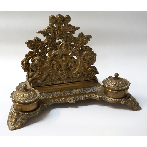 263 - VICTORIAN STYLE BRASS DESKSTAND
with scrolled and figural pierced decoration, letter rack, pen tray ... 