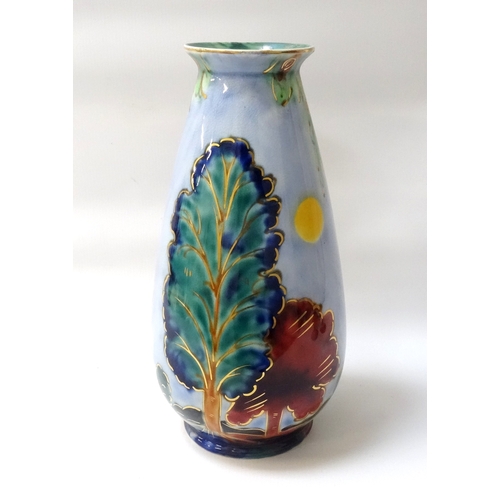 216 - BURLEIGH WARE VASE
of tapering form, decorated by W. Adams, decorated with trees on a pale blue grou... 