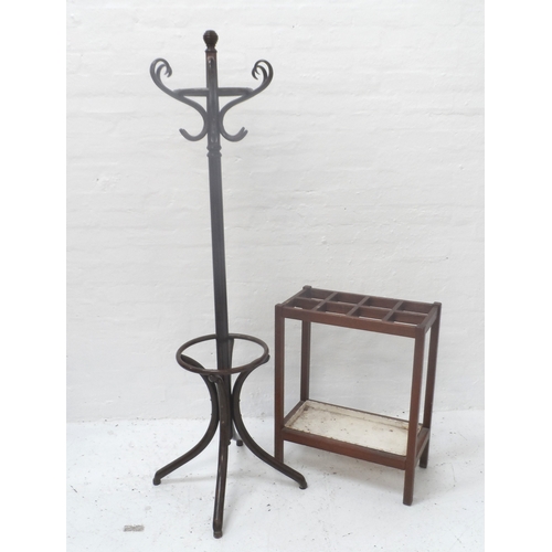 507 - TEAK STICK STAND
with eight open divisions and a painted inset drip pan below, standing on plain sup... 